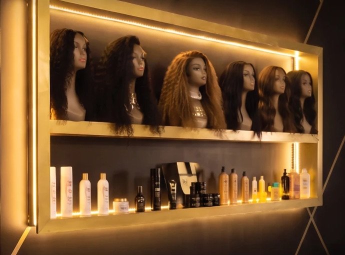 Raw Indian hair and wigs on a gold shelf